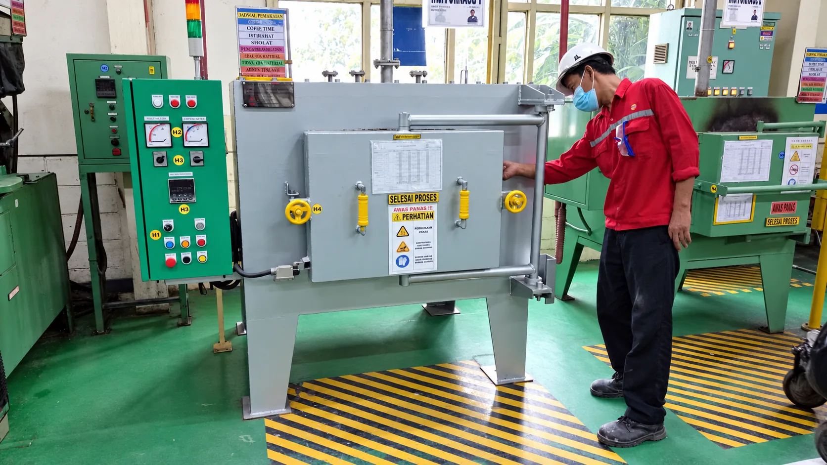 MWT compact chamber furnace with control panel, shown with a plant operator